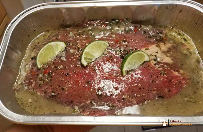 steak in marinade with garlic lime and seasoning